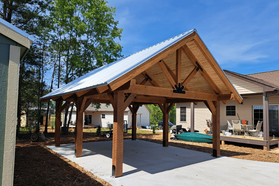 timber frame pavilions with a metal roof on a concrete pad