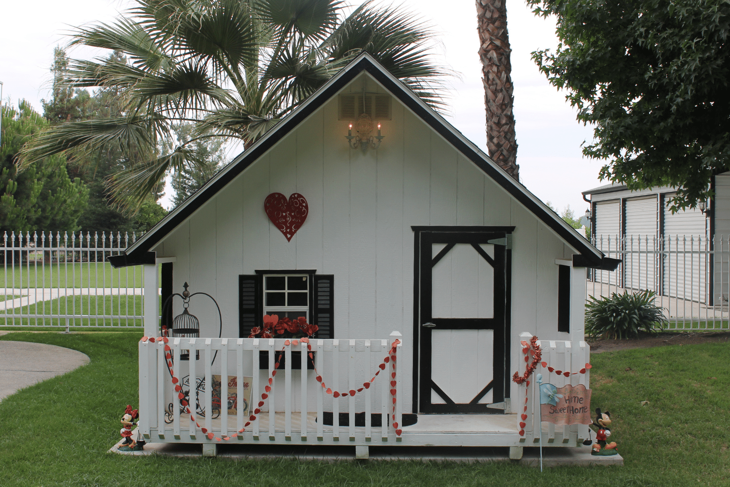 white playhouse with porch