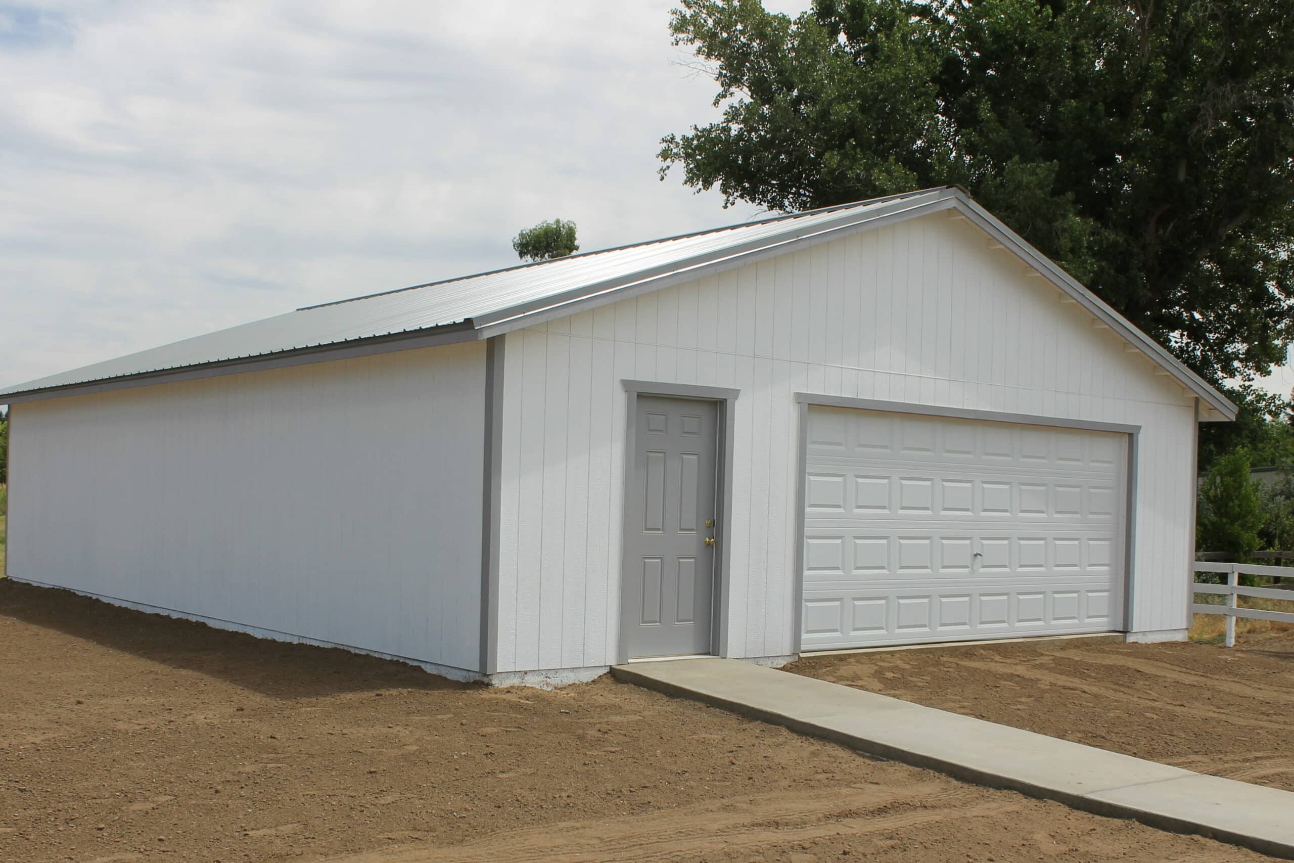 white two car garages in Clovis CA with sidewalk leading up to side door
